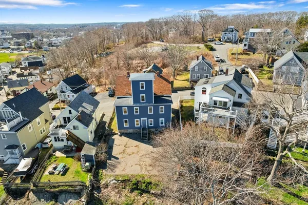 an aerial view of residential houses with yard