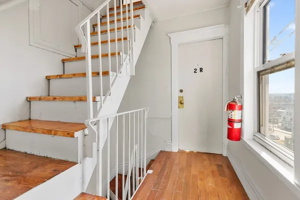 a view of an entryway with wooden floor