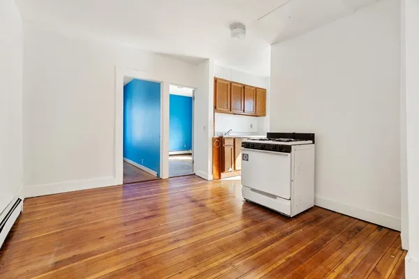 a view of kitchen with wooden floor and electronic appliances