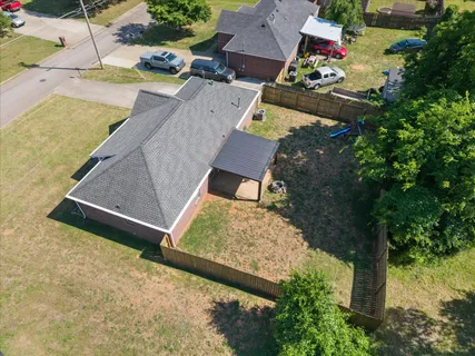 an aerial view of a house with a yard