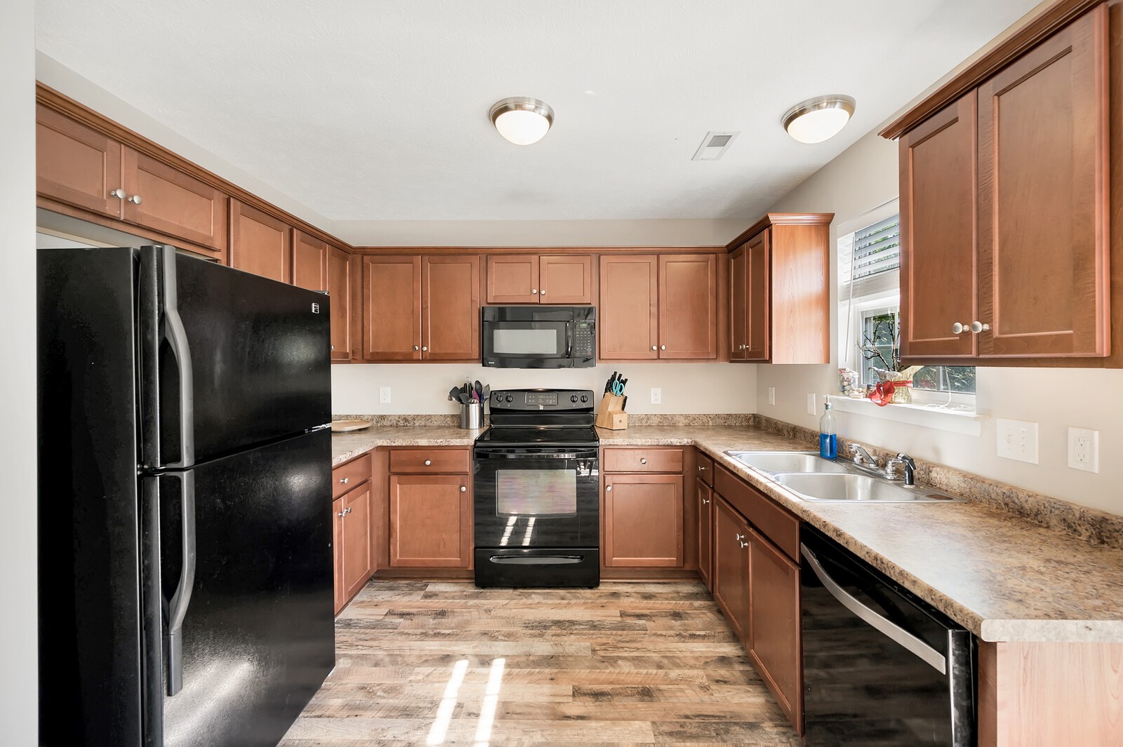 1129 Woodall Road Lebanon, TN 37090 - Photo 4 of 12 a kitchen with stainless steel appliances granite countertop a refrigerator stove and sink