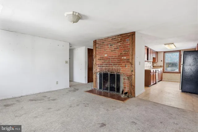 a kitchen with stainless steel appliances granite countertop a refrigerator a stove top oven a sink and dishwasher