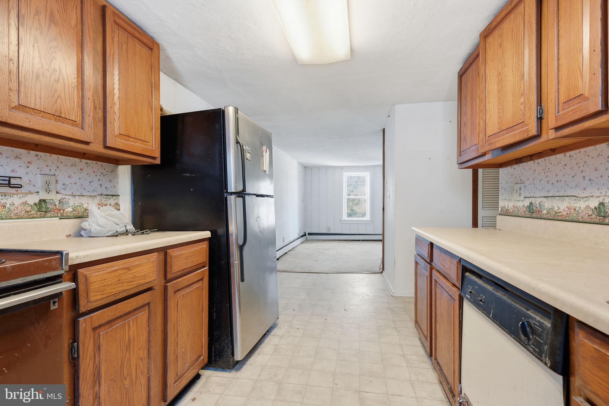 2695 Main Street Lawrence Township, NJ 08648 - Photo 17 of 50 a kitchen with stainless steel appliances granite countertop a refrigerator stove and cabinets