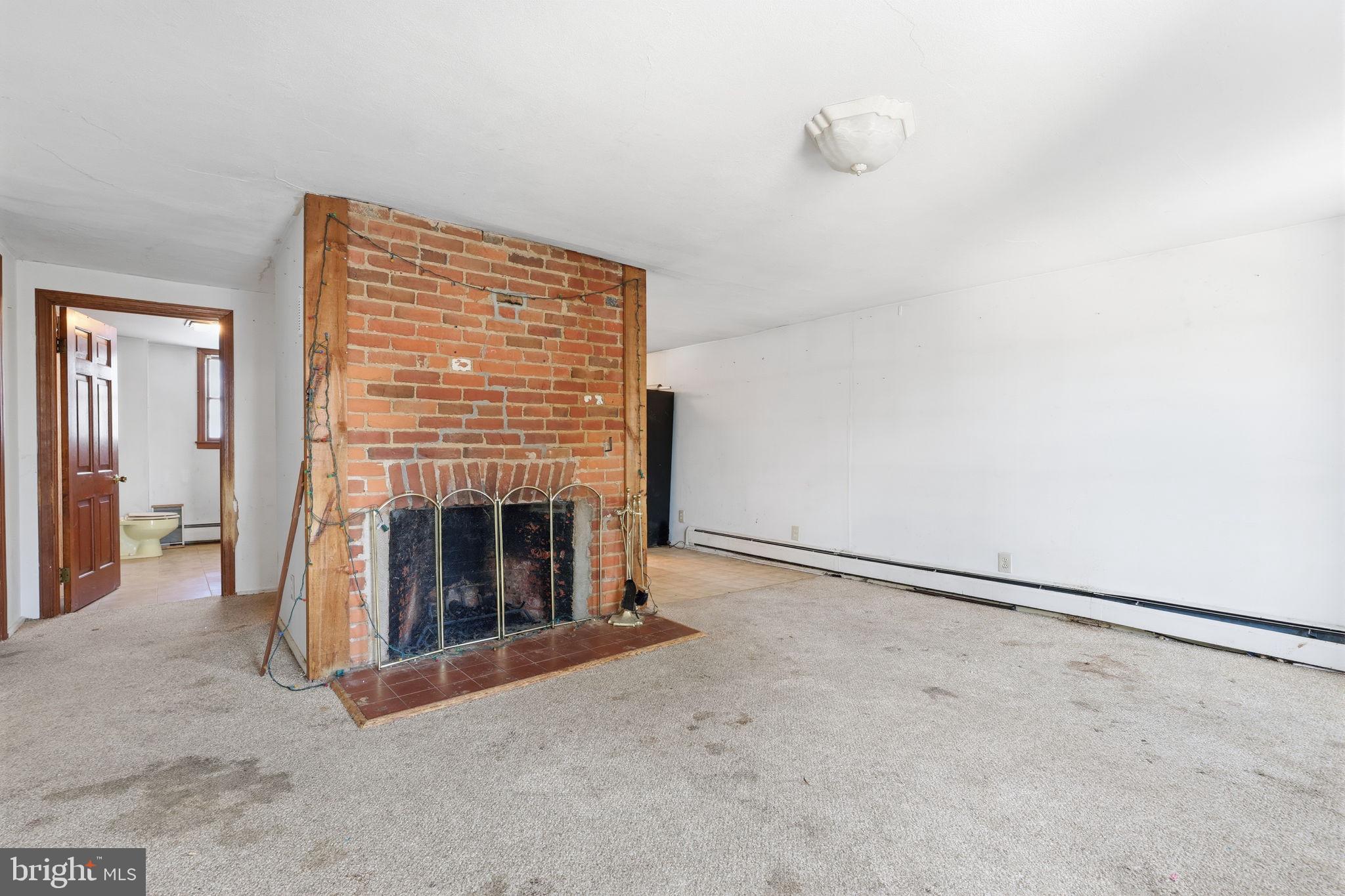 2695 Main Street Lawrence Township, NJ 08648 - Photo 19 of 50 a view of an empty room with a fireplace and a window