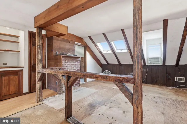 a view of a room with a wooden door