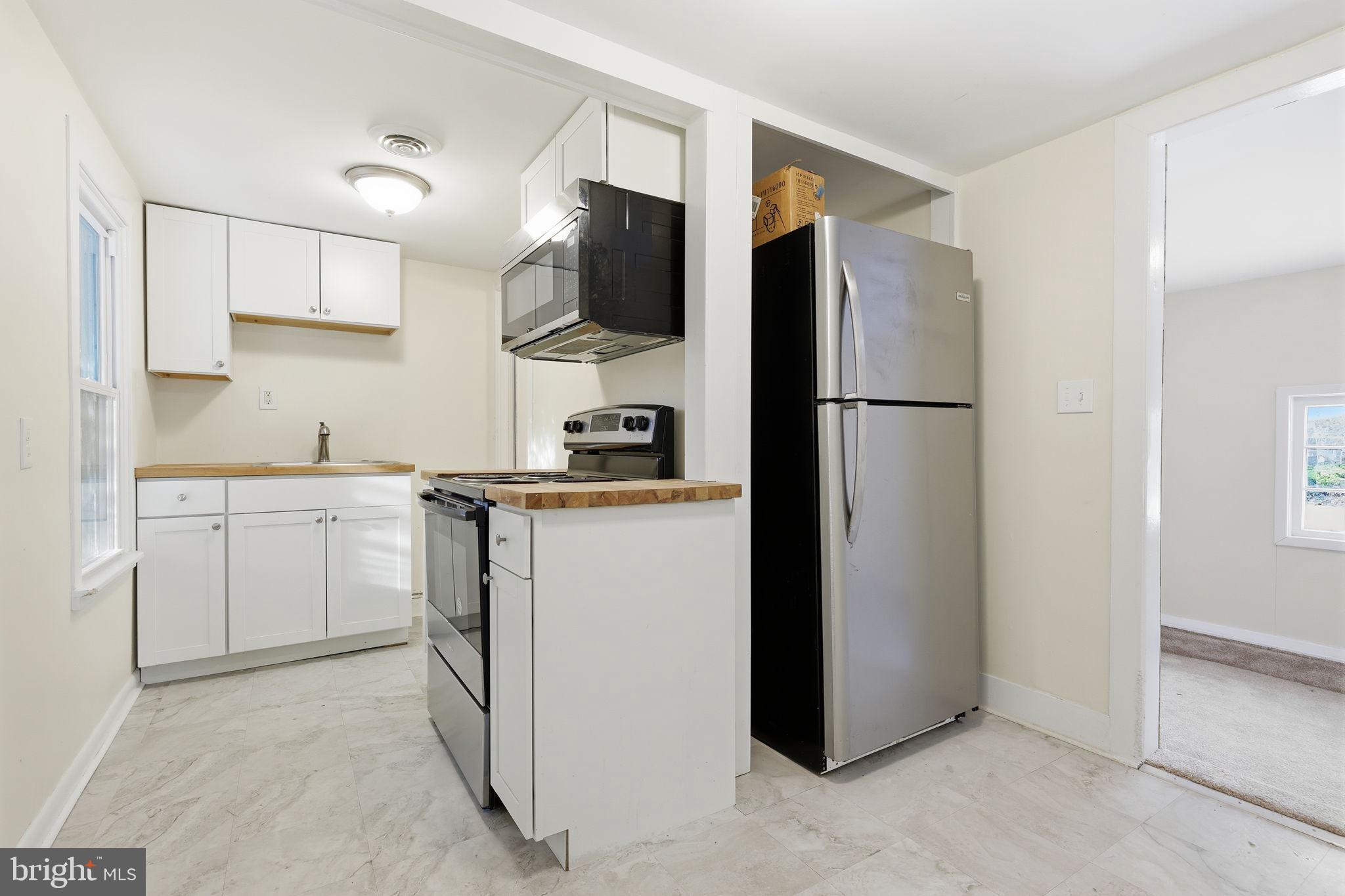 2695 Main Street Lawrence Township, NJ 08648 - Photo 42 of 50 a kitchen with a refrigerator sink and cabinets