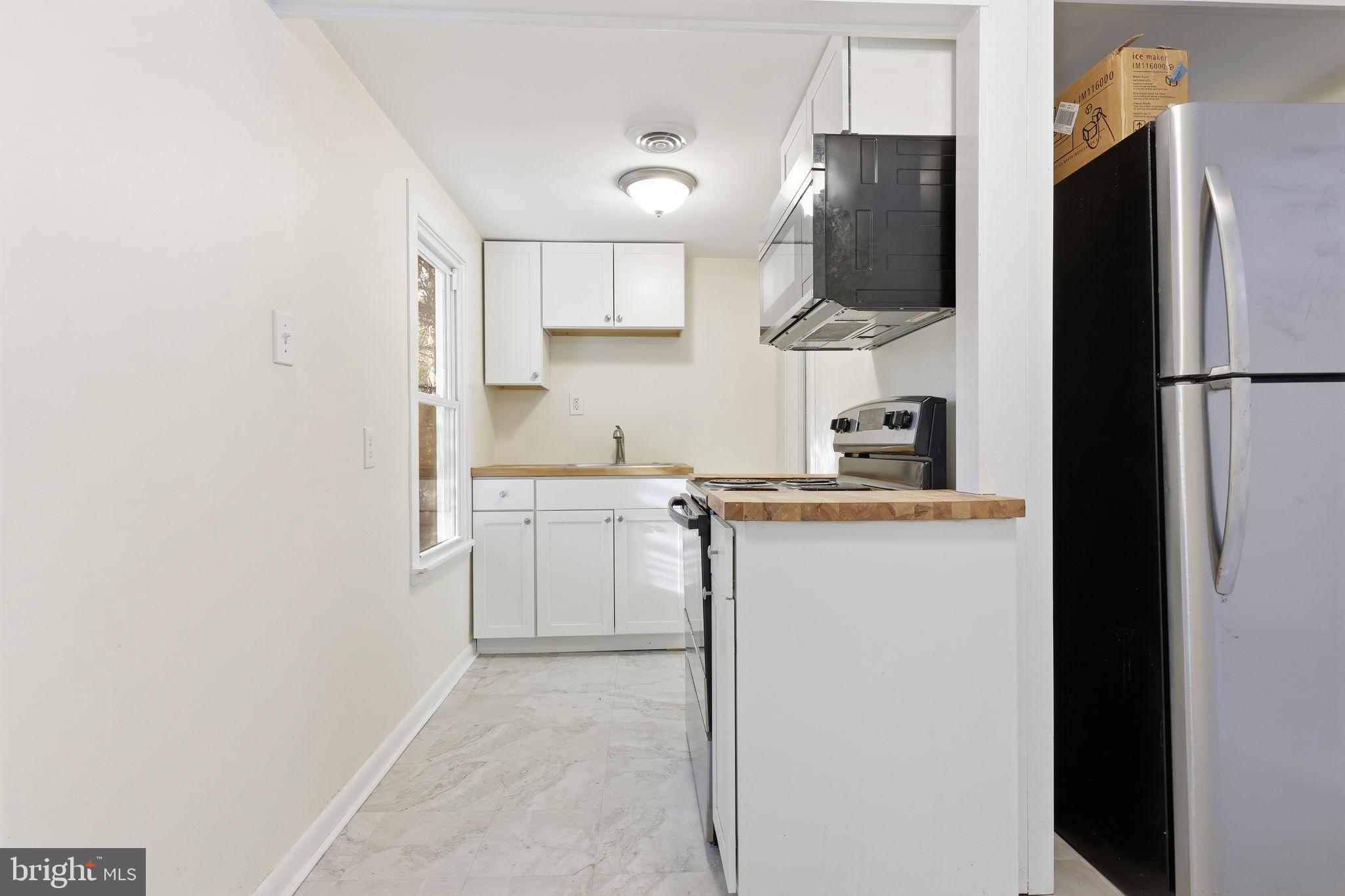 2695 Main Street Lawrence Township, NJ 08648 - Photo 43 of 50 a kitchen with a sink and refrigerator
