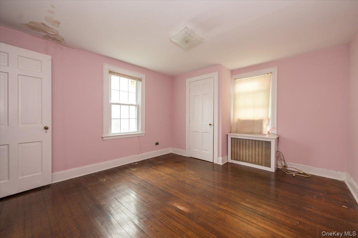 1 Edna Place New Rochelle, NY 10804 - Photo 13 of 24 an empty room with wooden floor and windows