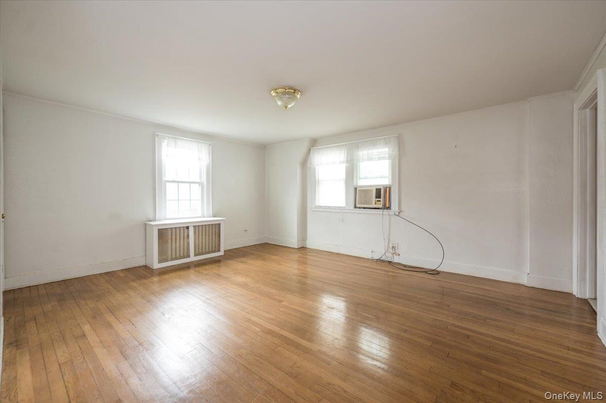 1 Edna Place New Rochelle, NY 10804 - Photo 14 of 24 an empty room with wooden floor and windows