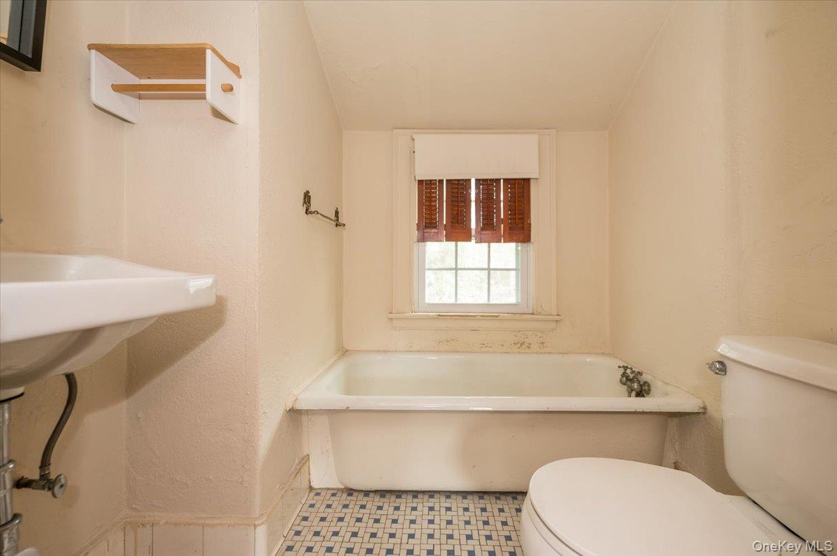 1 Edna Place New Rochelle, NY 10804 - Photo 16 of 24 a bathroom with a sink a toilet and bathtub