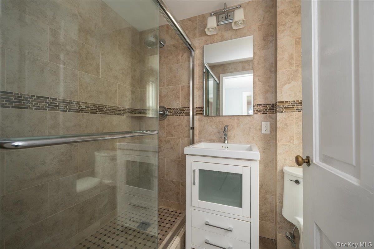 1 Edna Place New Rochelle, NY 10804 - Photo 17 of 24 a bathroom with a shower and a sink