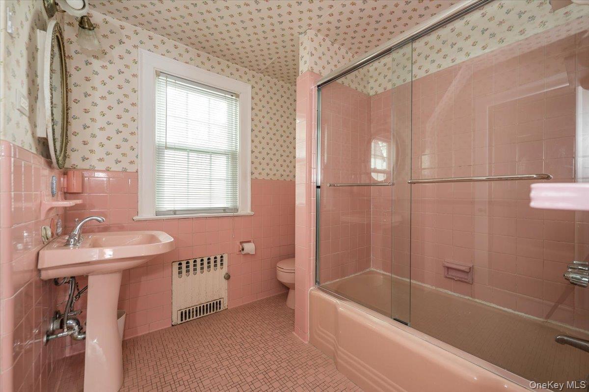 1 Edna Place New Rochelle, NY 10804 - Photo 18 of 24 a bathroom with a sink a toilet and a bathtub
