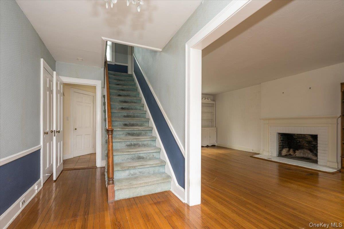 1 Edna Place New Rochelle, NY 10804 - Photo 2 of 24 a view of a livingroom with wooden floor and a fireplace