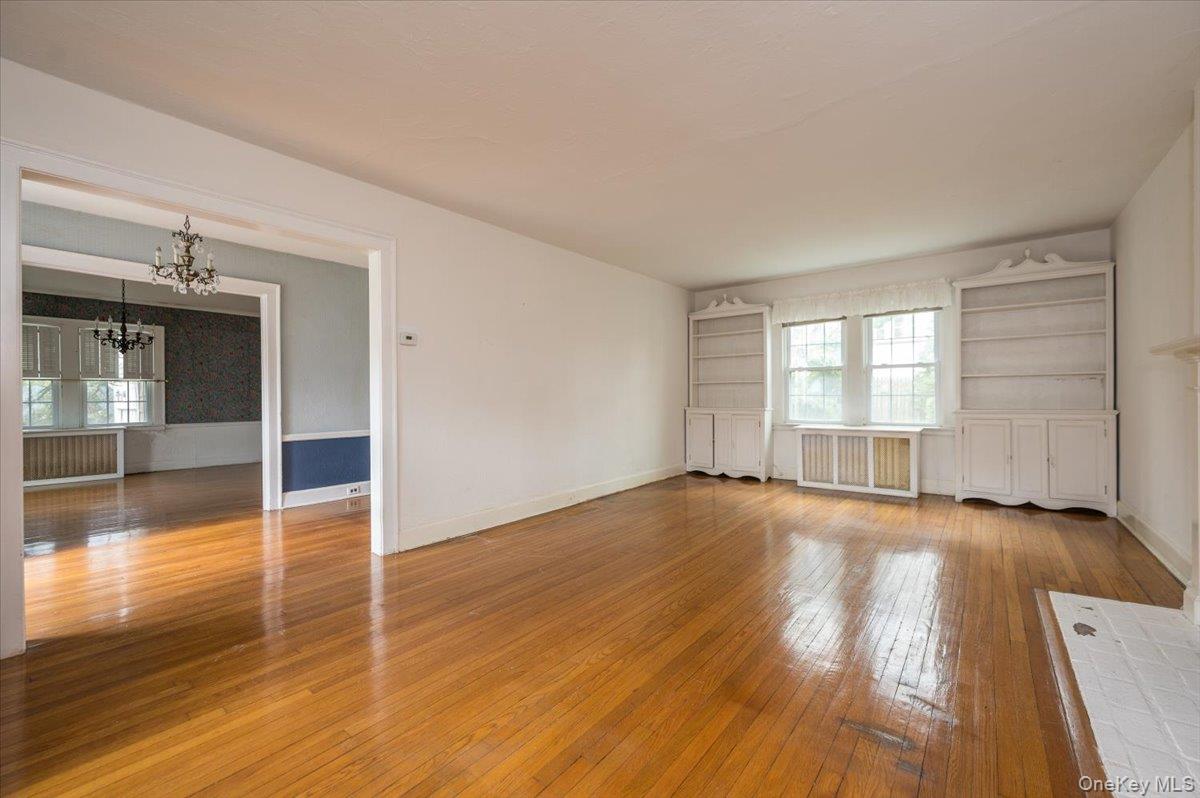 1 Edna Place New Rochelle, NY 10804 - Photo 4 of 24 an empty room with wooden floor and windows
