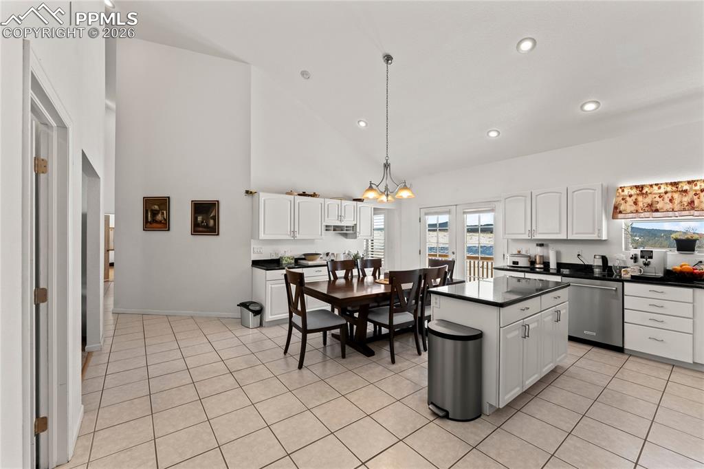 112 Ridge Point Circle Divide, CO 80814 - Photo 18 of 50 a kitchen with a sink dining table and chairs
