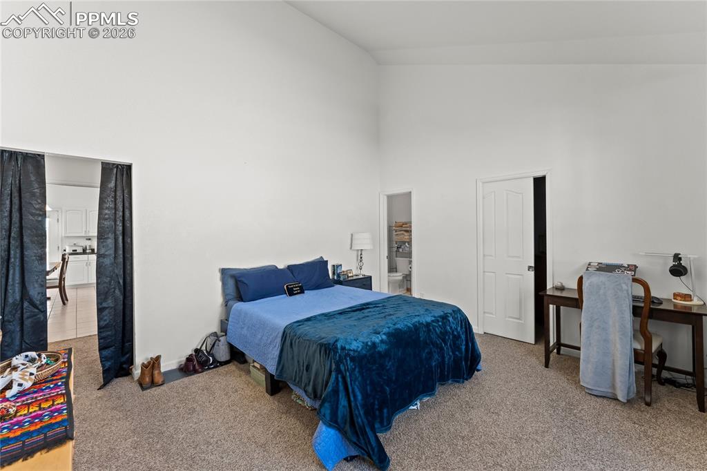 112 Ridge Point Circle Divide, CO 80814 - Photo 21 of 50 a bedroom with a bed and a table in it