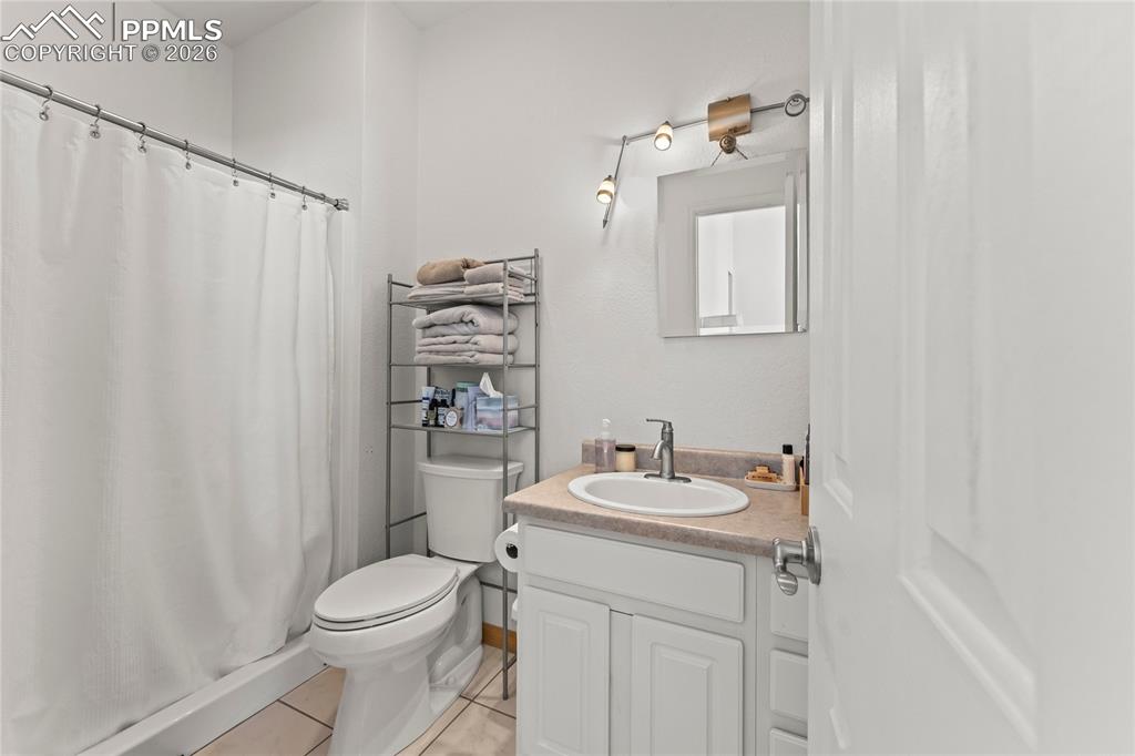 112 Ridge Point Circle Divide, CO 80814 - Photo 22 of 50 a bathroom with a sink a toilet and shower curtain