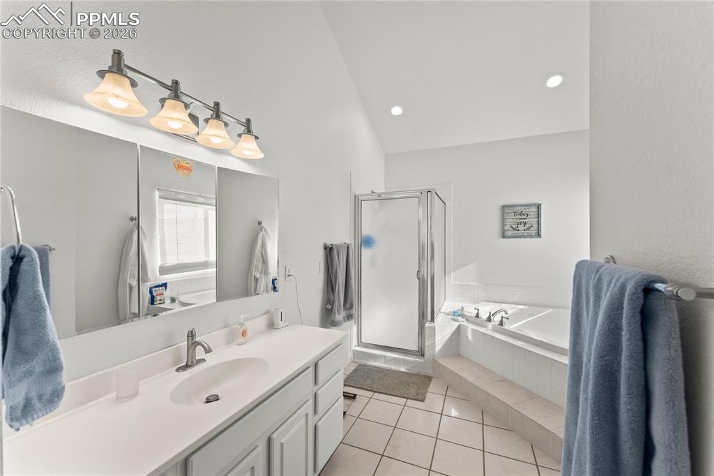 112 Ridge Point Circle Divide, CO 80814 - Photo 26 of 50 a bathroom with a double vanity sink mirror and shower