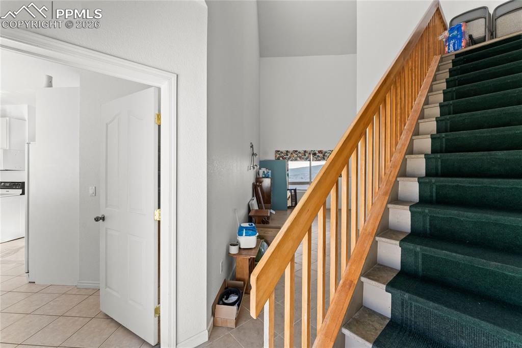 112 Ridge Point Circle Divide, CO 80814 - Photo 30 of 50 a view of staircase with lots of frames on wall and wooden floor