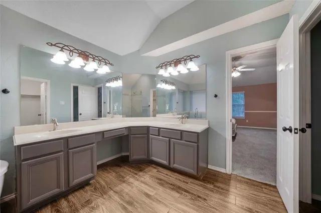 a spacious bathroom with a double vanity sink and a mirror