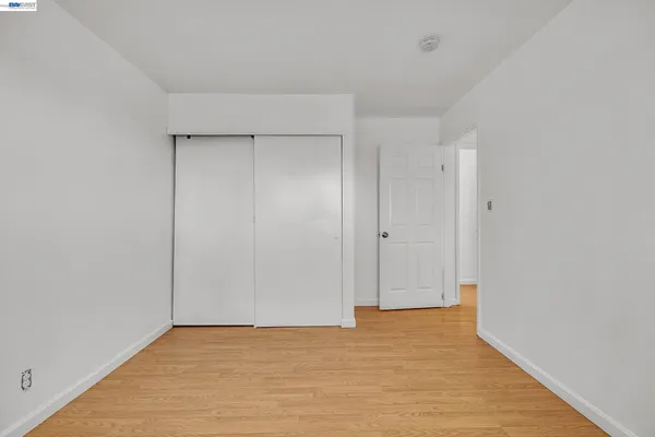 a yellow house with trees in front of it