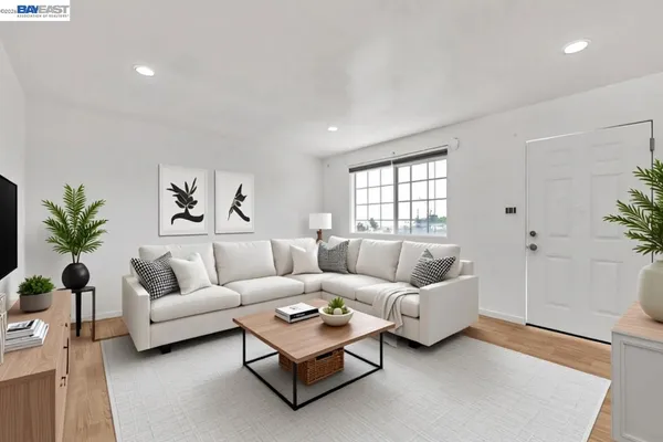 a living room with furniture and a potted plant