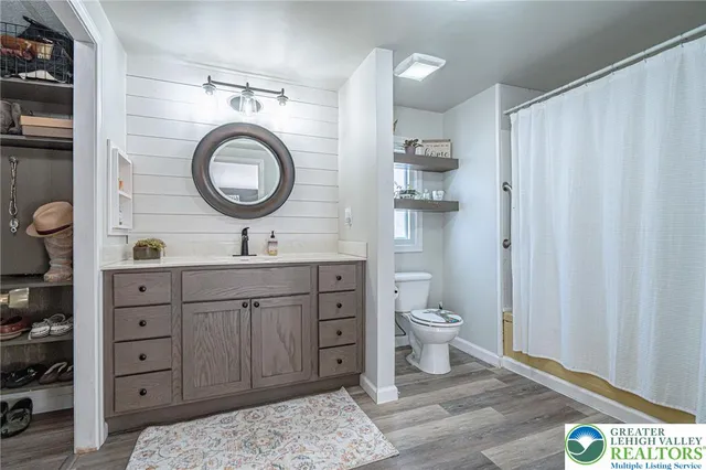 a bathroom with a toilet a sink and a mirror