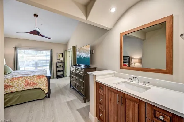a spacious bathroom with a granite countertop sink and a mirror