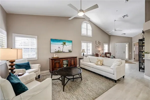 a living room with furniture a bed and a window