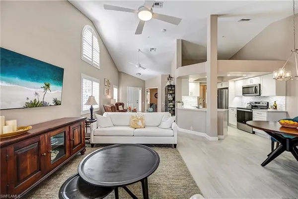 a living room with stainless steel appliances kitchen island granite countertop furniture and a kitchen view