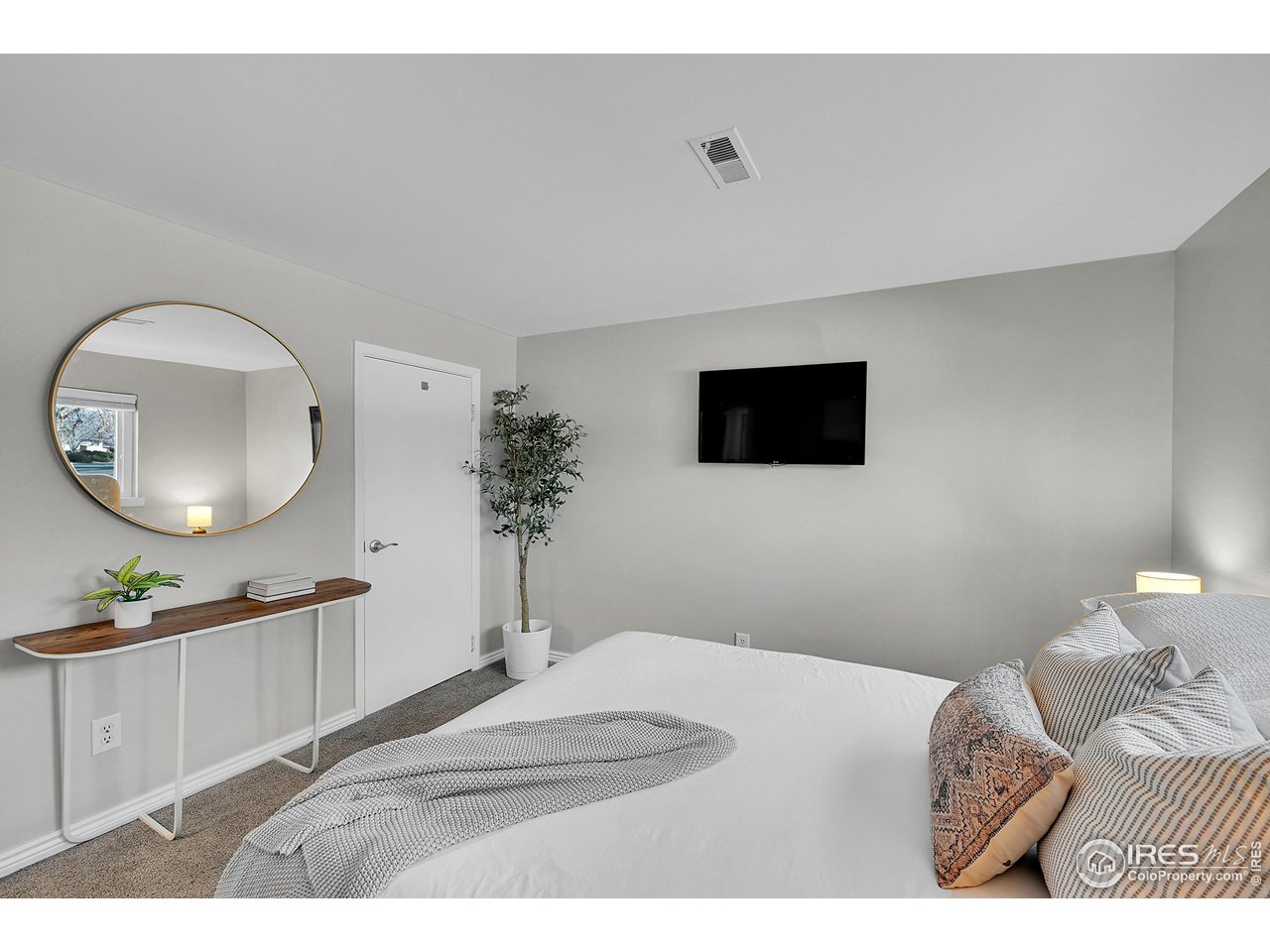 4216 Evans Drive Boulder, CO 80303 - Photo 14 of 26 a bedroom with a bed and a flat screen tv