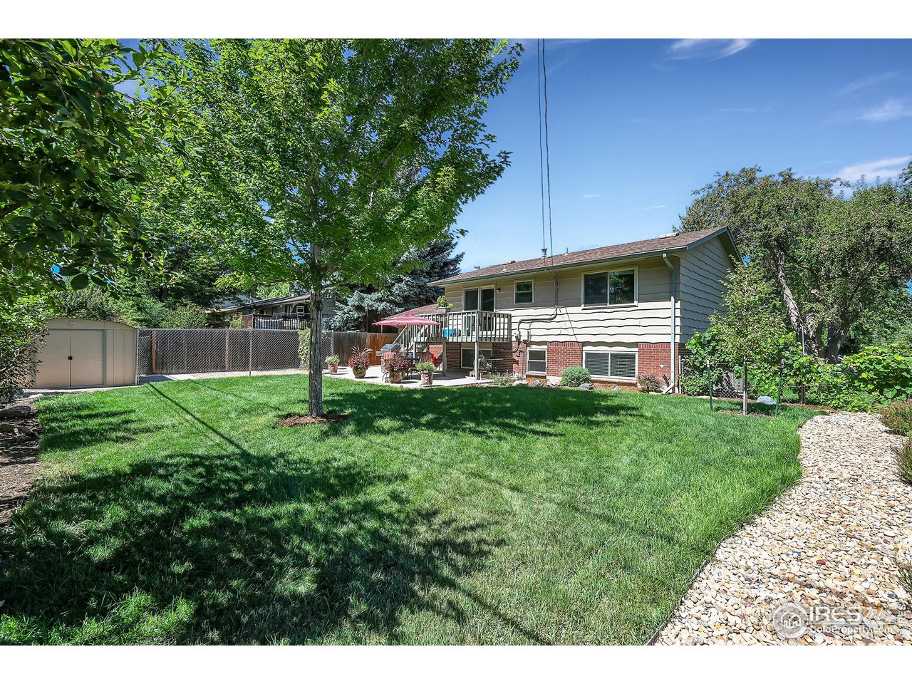 4216 Evans Drive Boulder, CO 80303 - Photo 24 of 26 a view of a backyard with table and chairs plants and large tree