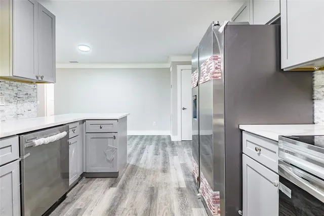 a kitchen with stainless steel appliances granite countertop a refrigerator and a sink