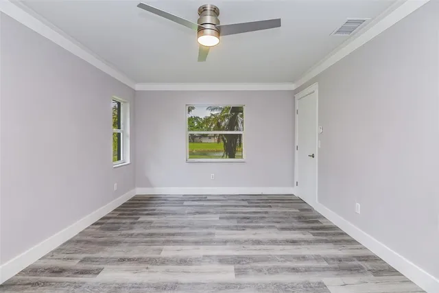 wooden floor in an empty room with a window