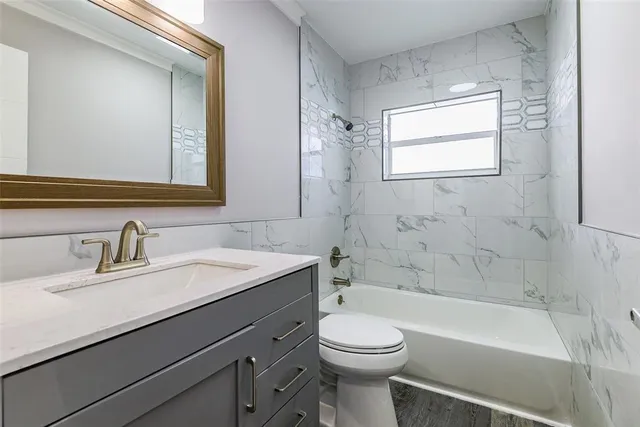 a bathroom with a sink a toilet and bathtub