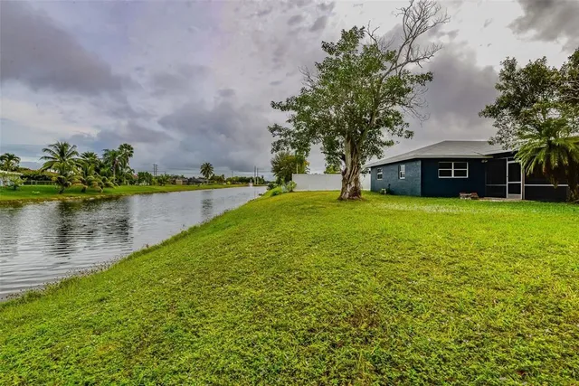 a view of a house with a yard and sitting area