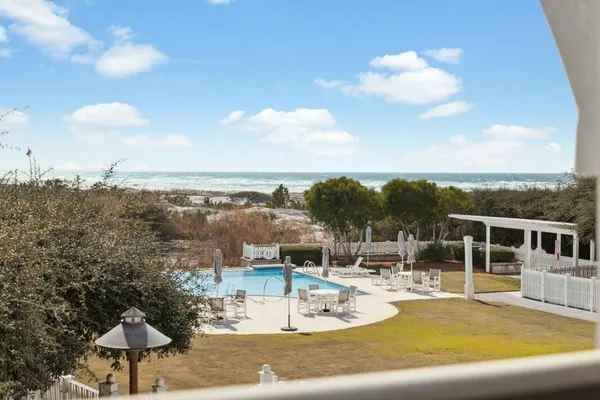 a view of a swimming pool with a table and chairs
