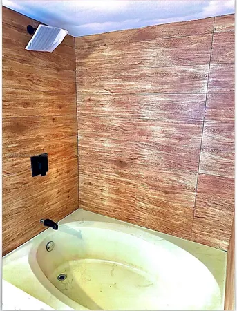 a bathroom with a bathtub and shower