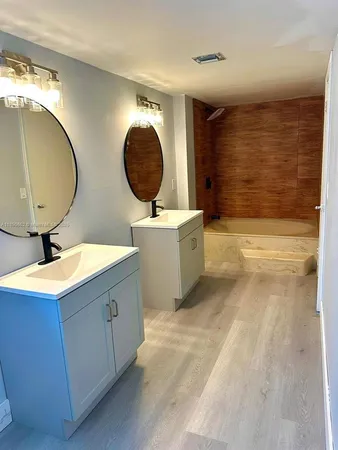 a bathroom with a sink mirror and vanity