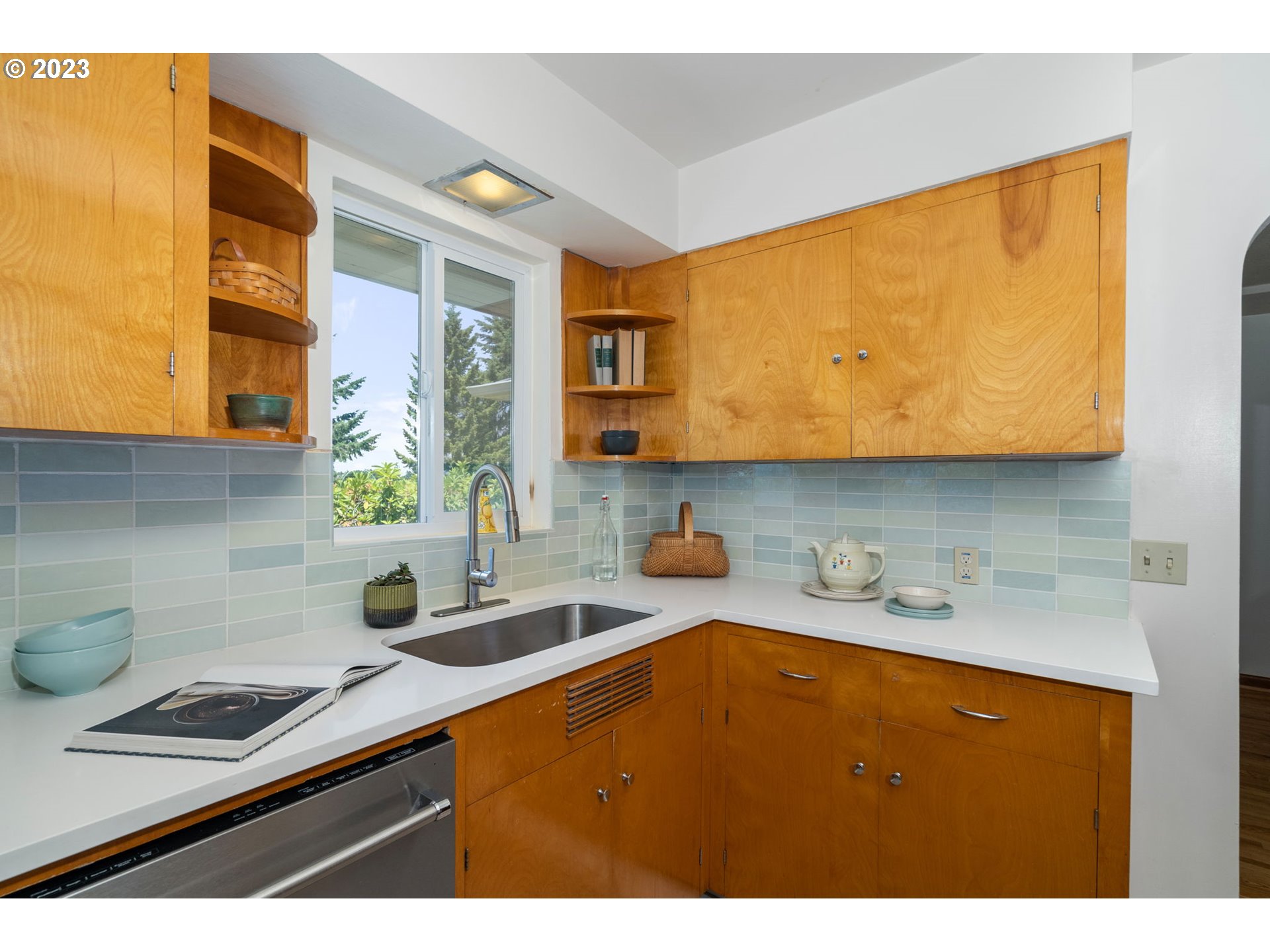 12050 Southwest 29th Avenue Portland, OR 97219 - Photo 12 of 36 a kitchen with a sink a stove and cabinets