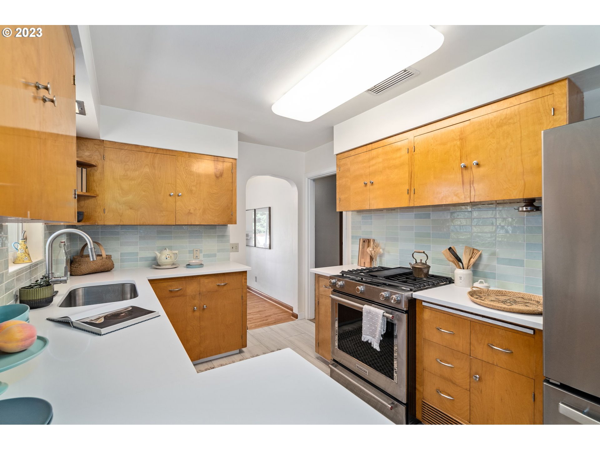 12050 Southwest 29th Avenue Portland, OR 97219 - Photo 13 of 36 a kitchen with stainless steel appliances granite countertop a stove a sink and a microwave