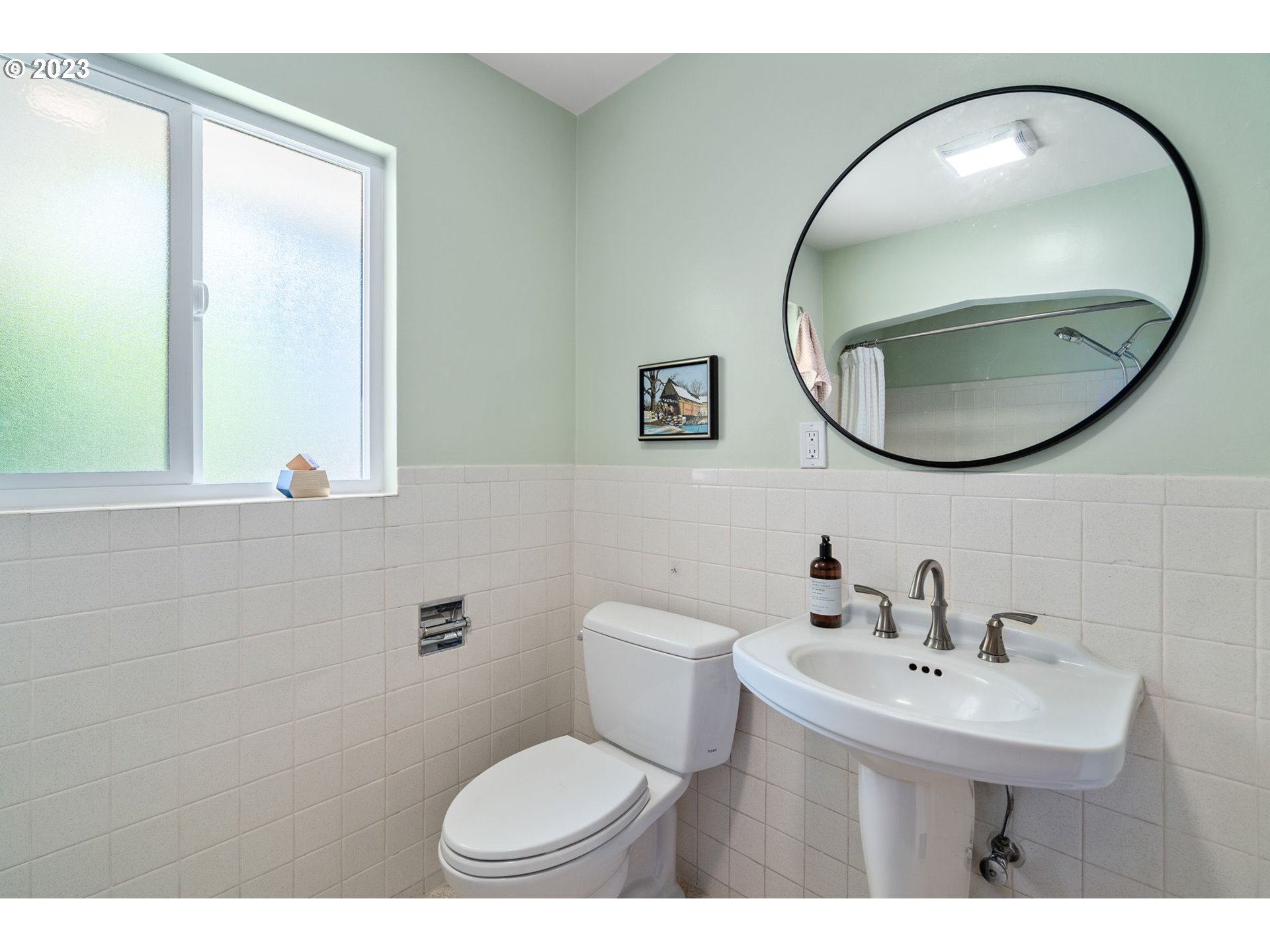 12050 Southwest 29th Avenue Portland, OR 97219 - Photo 18 of 36 a bathroom with a sink a mirror and a toilet