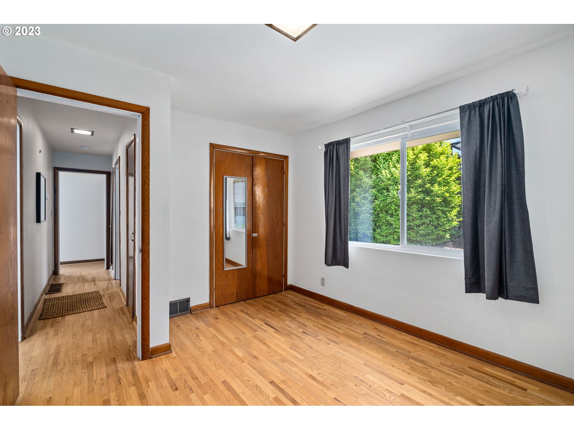 12050 Southwest 29th Avenue Portland, OR 97219 - Photo 20 of 36 a view of an empty room with wooden floor and a window