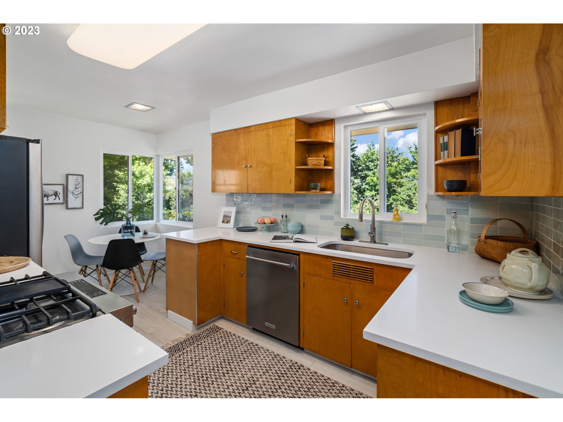 12050 Southwest 29th Avenue Portland, OR 97219 - Photo 10 of 36 a kitchen with stainless steel appliances granite countertop a sink counter space and a window