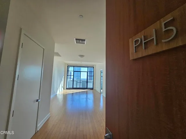 a view of an entryway with wooden floor