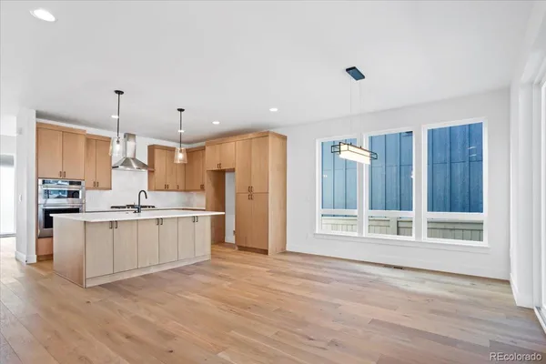 a kitchen with a refrigerator a sink and cabinets