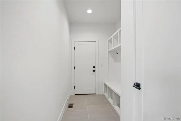 a view of kitchen with cabinet and a projector screen