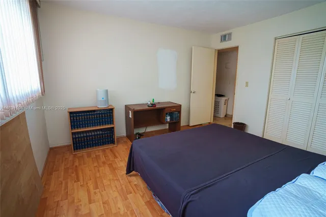 a bedroom with a bed and dresser