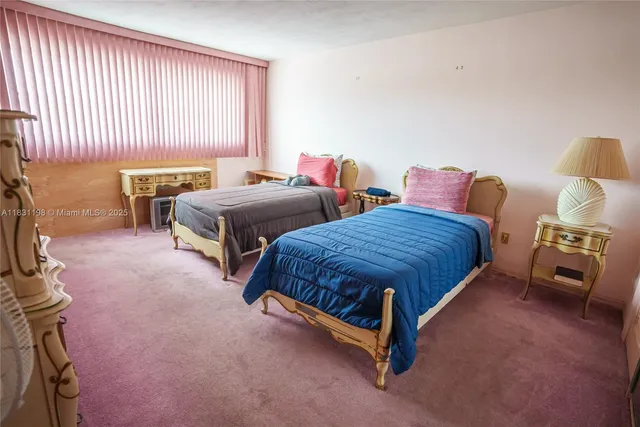 a spacious bedroom with two beds and a couch