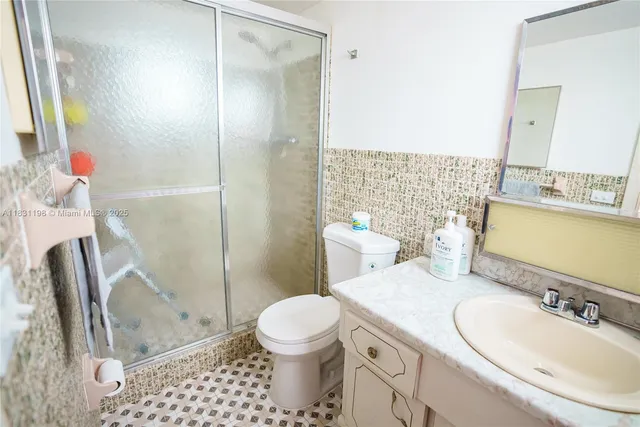 a bathroom with a sink toilet and shower